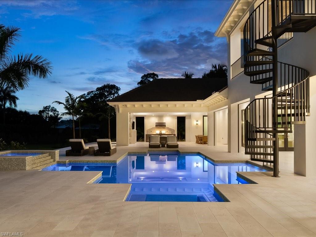 142 Eugenia Drive Naples, FL 34108 - Photo 32 of 35 a view of a house with swimming pool and sitting area
