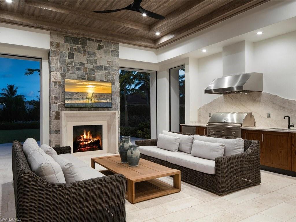 142 Eugenia Drive Naples, FL 34108 - Photo 34 of 35 a living room with furniture and a fireplace