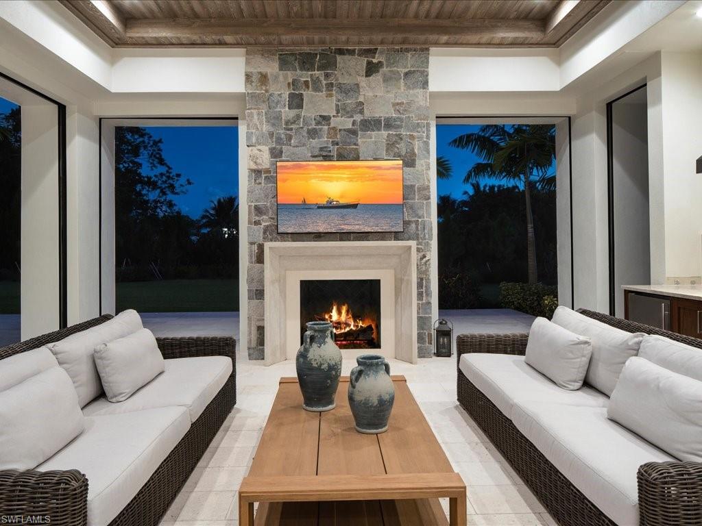 142 Eugenia Drive Naples, FL 34108 - Photo 35 of 35 a living room with furniture and a fireplace