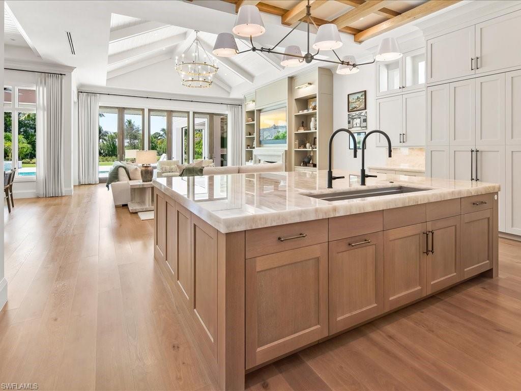 142 Eugenia Drive Naples, FL 34108 - Photo 7 of 35 a very nice looking kitchen with lots of counter space a sink and living room view
