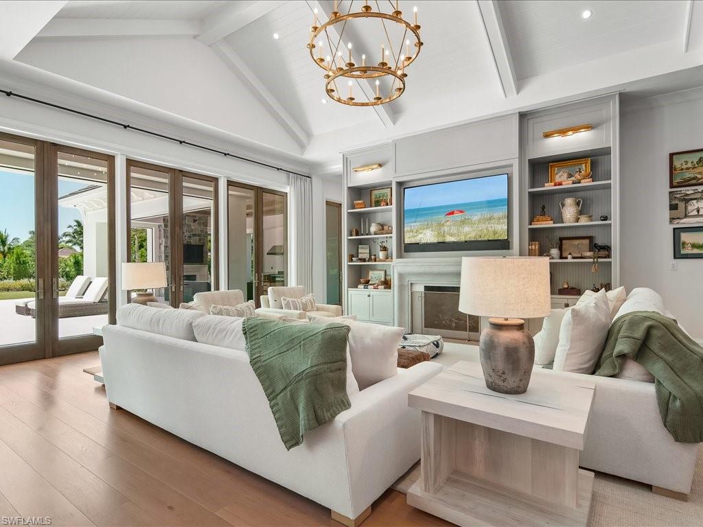 142 Eugenia Drive Naples, FL 34108 - Photo 8 of 35 a living room with furniture fireplace and flat screen tv