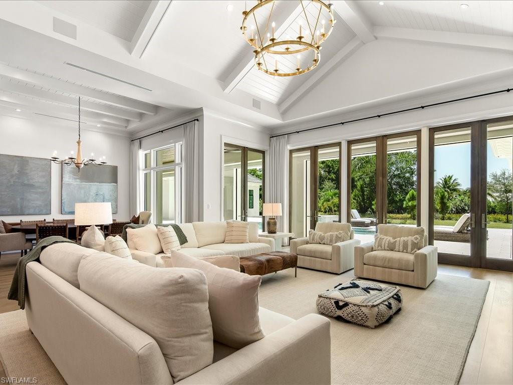 142 Eugenia Drive Naples, FL 34108 - Photo 10 of 35 a living room with furniture and floor to ceiling windows