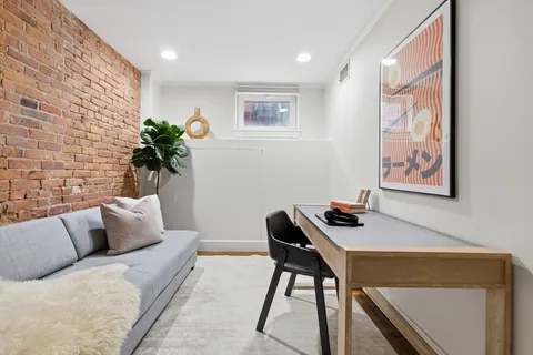 a workstation with a desk chair and a couch with garden view