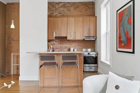 a kitchen with a white stove top oven and sink