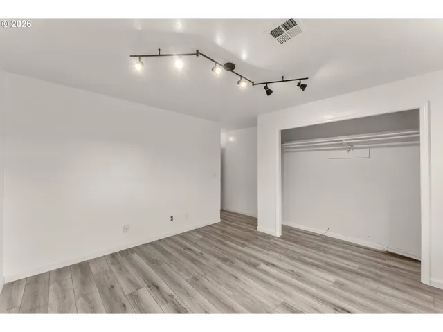a bathroom with a granite countertop sink toilet a large mirror a shower and bathtub