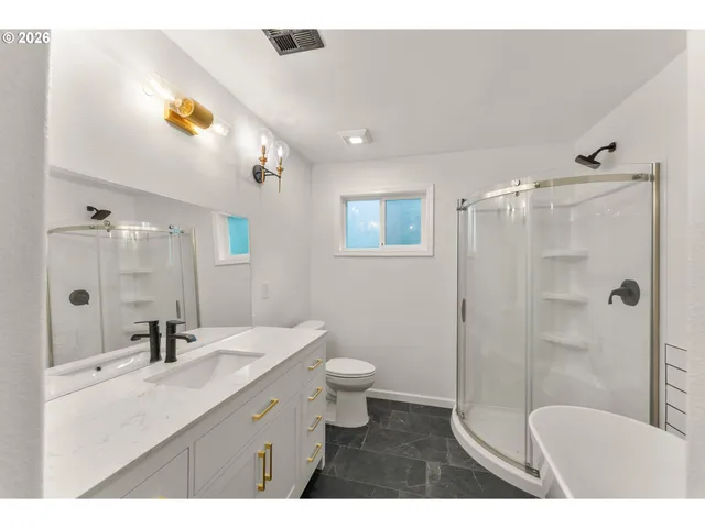 a bathroom with a bathtub and shower