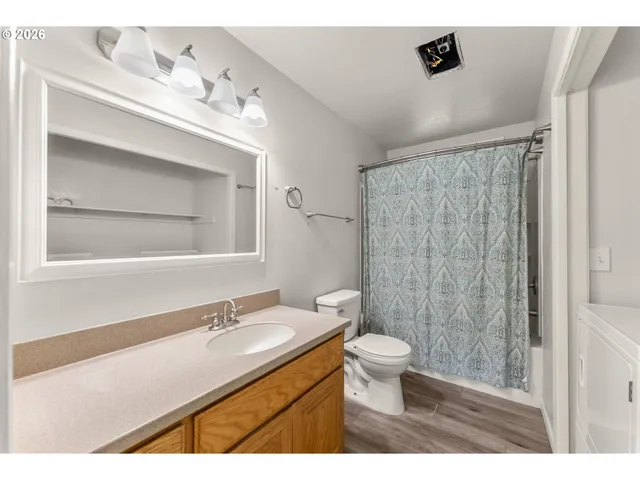 a bathroom with a toilet a sink and a shower