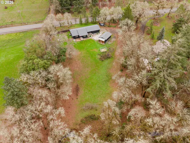 a aerial view of a house with a yard basket ball court