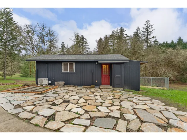 a backyard of a house with table and chairs