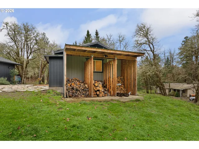 a kitchen with a refrigerator and a wooden floor