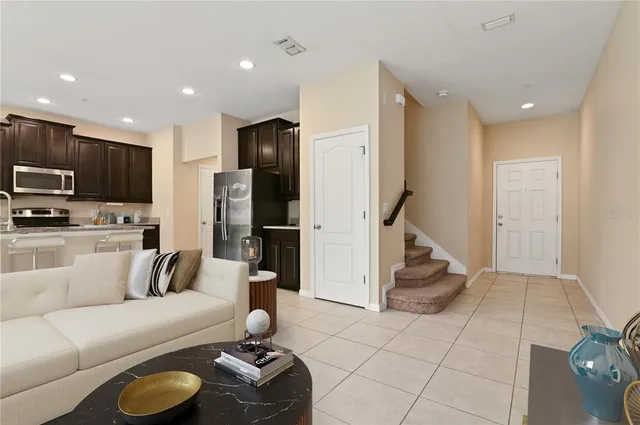 a kitchen with stainless steel appliances granite countertop a sink a stove and a refrigerator