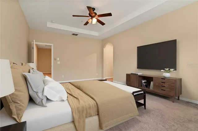 a bedroom with a bed and a lamp on the dresser