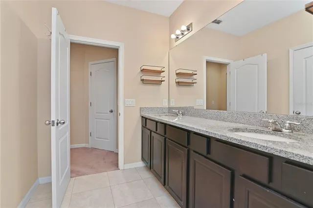 an empty room that has a window and kitchen view