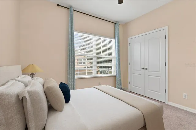 an empty room with closet and a chandelier fan
