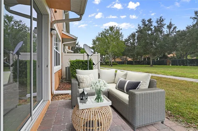 a front view of a house with swimming pool and porch with furniture