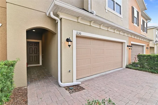 a living room with couches and a dining table with kitchen view