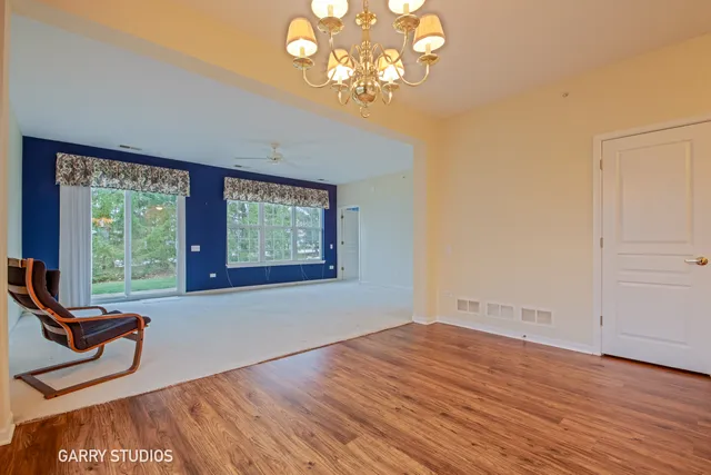a view of a room with wooden floor and windows