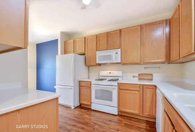 a kitchen with a sink a stove a refrigerator and cabinets