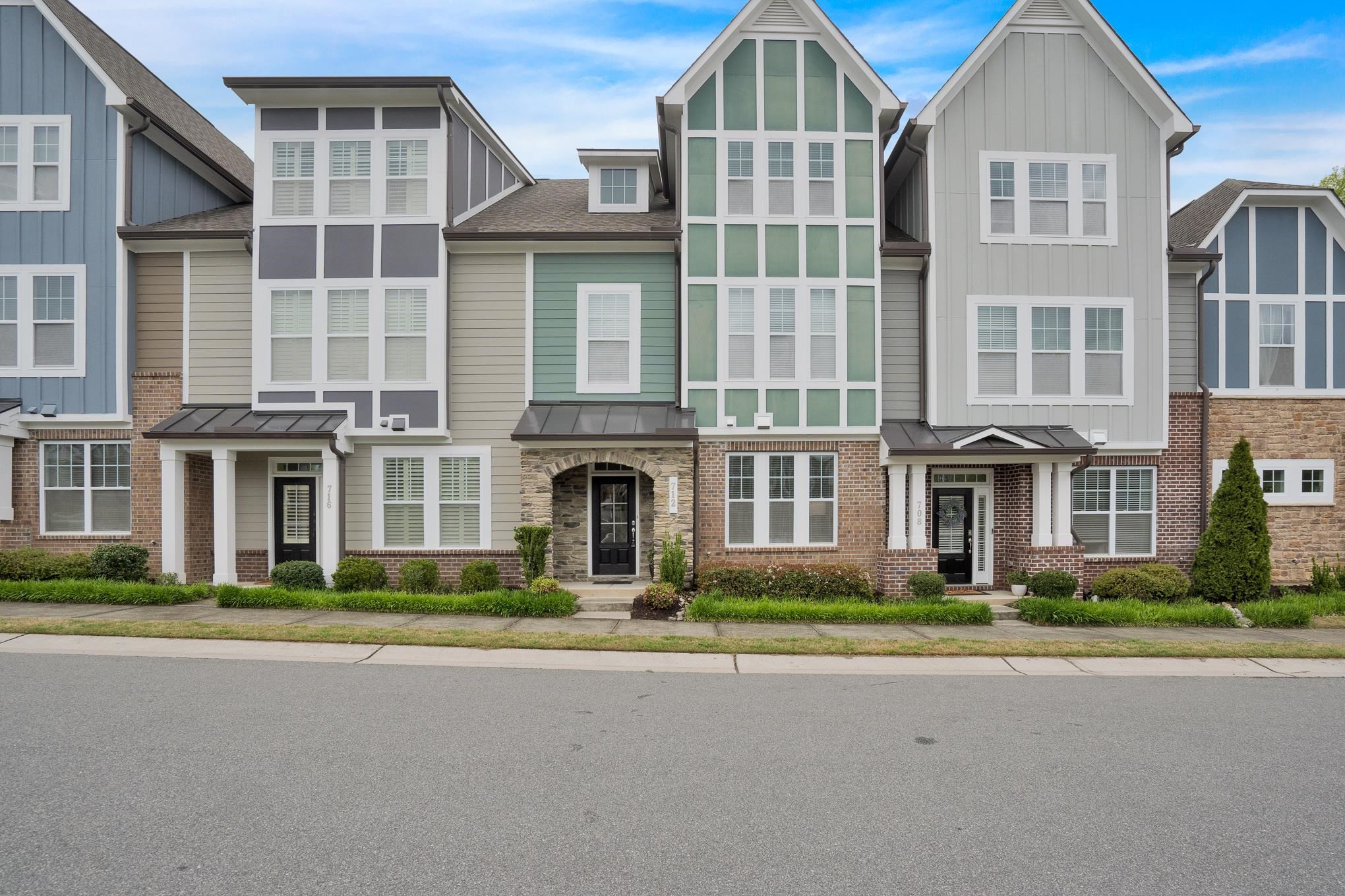 712 Fallon Grove Way Raleigh, NC 27608 - Photo 1 of 20 a front view of a residential apartment building with a yard