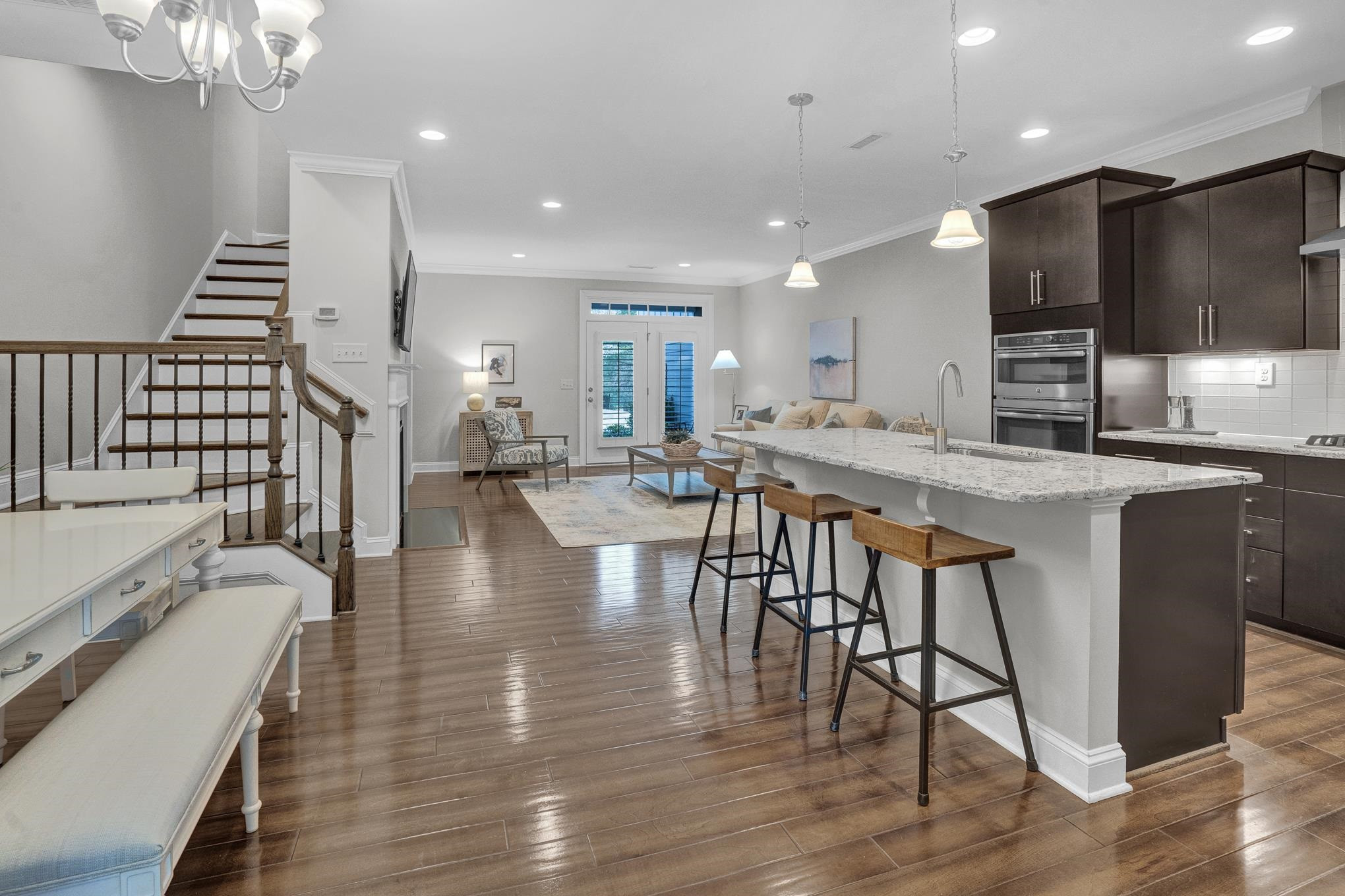 712 Fallon Grove Way Raleigh, NC 27608 - Photo 3 of 20 an open kitchen with wooden floor and stainless steel appliances
