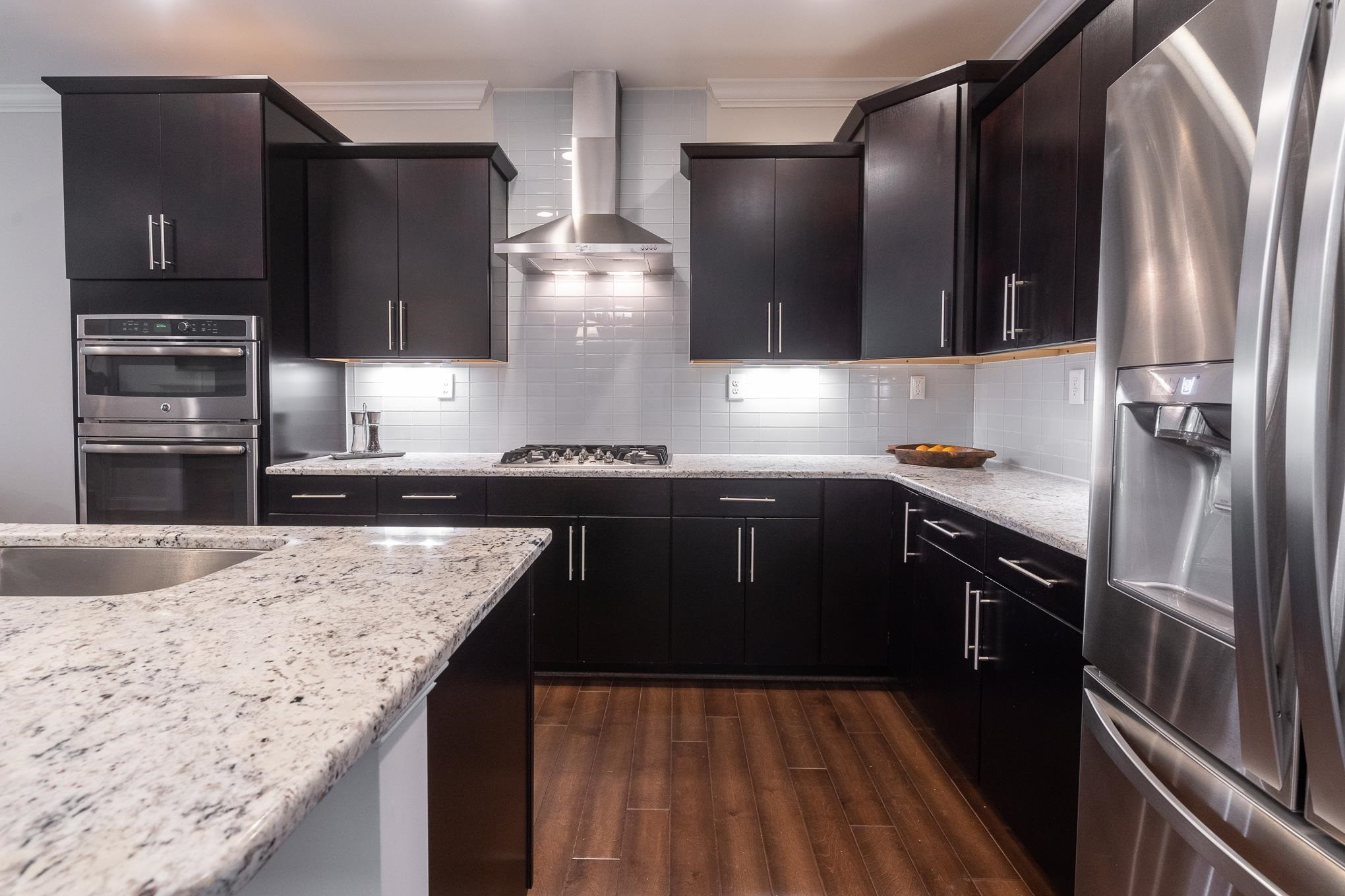 712 Fallon Grove Way Raleigh, NC 27608 - Photo 4 of 20 a kitchen with a sink stove and refrigerator