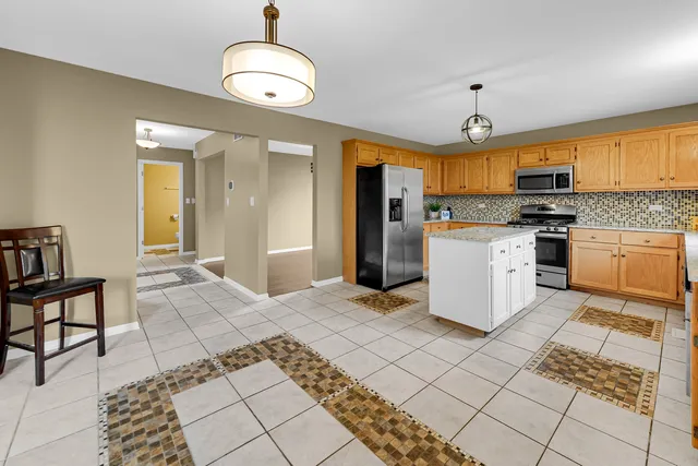 a kitchen with stainless steel appliances granite countertop a stove top oven a sink a counter space and cabinets