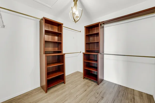 a view of walk in closet with empty racks