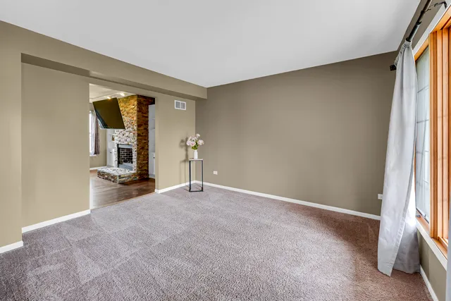 an empty room with closet and mirror