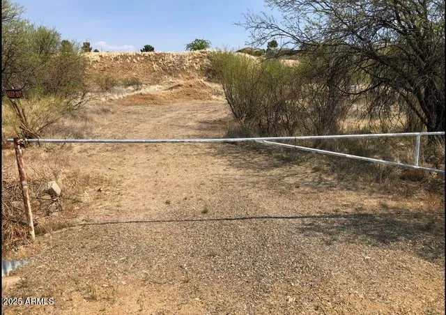 an aerial view of mountains with green space and fog