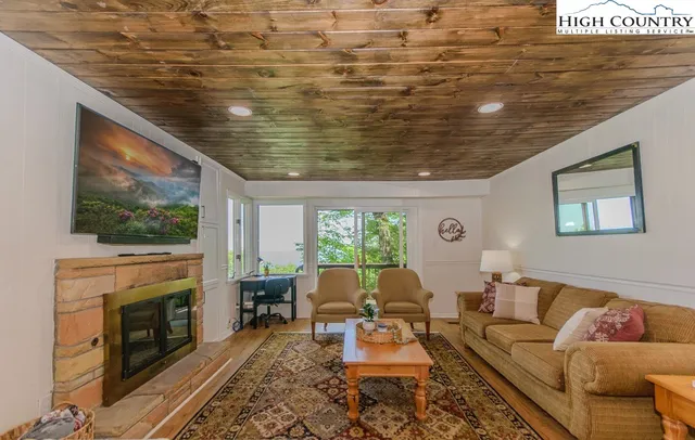 a living room with furniture wooden floor and a fireplace
