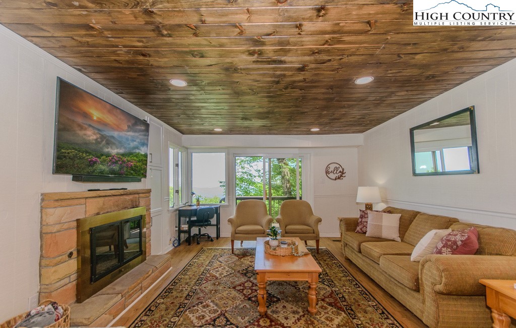 a living room with furniture wooden floor and a fireplace