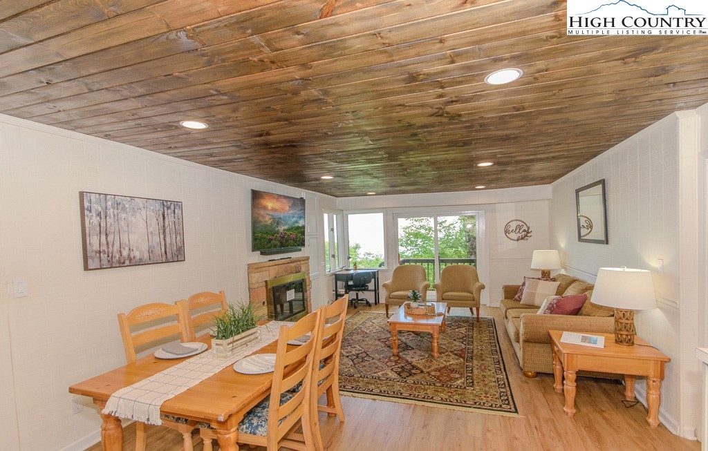 220 Northridge Road, Unit 25 Beech Mountain, NC 28604 - Photo 12 of 47 a living room with furniture a flat screen tv and a large window