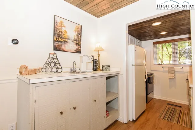 a spacious bedroom with a bed and a chandelier