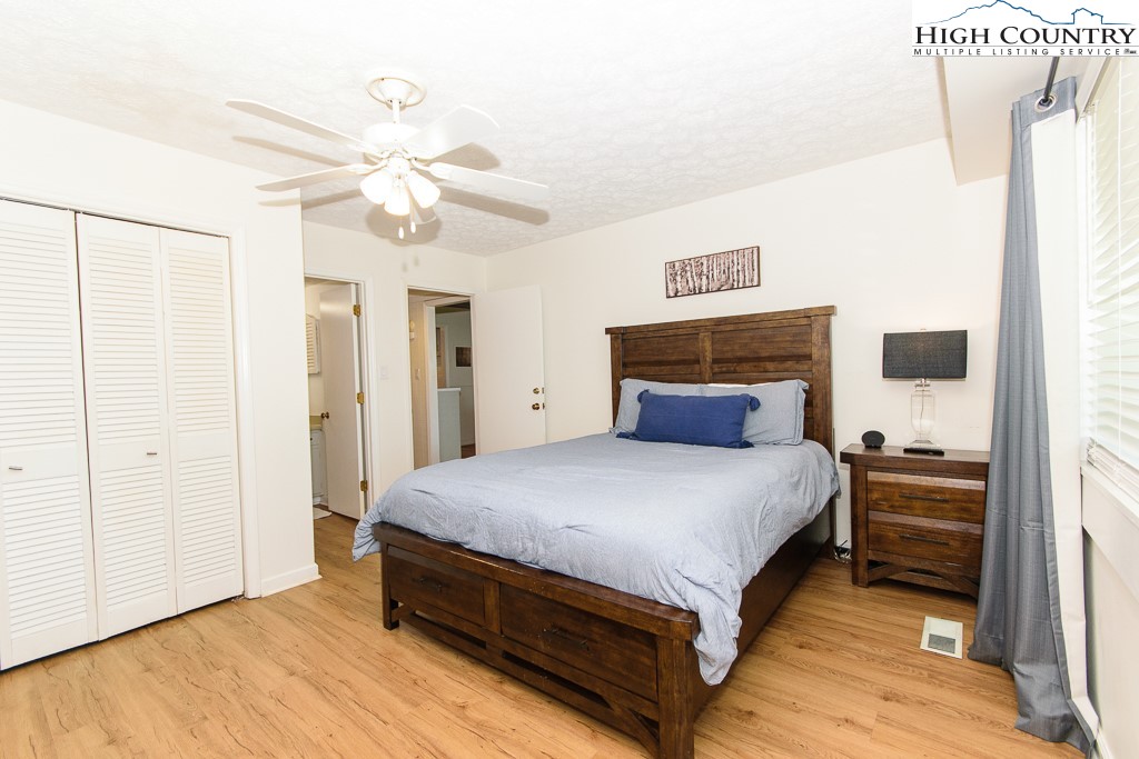 220 Northridge Road, Unit 25 Beech Mountain, NC 28604 - Photo 19 of 47 a spacious bedroom with a bed and a chandelier