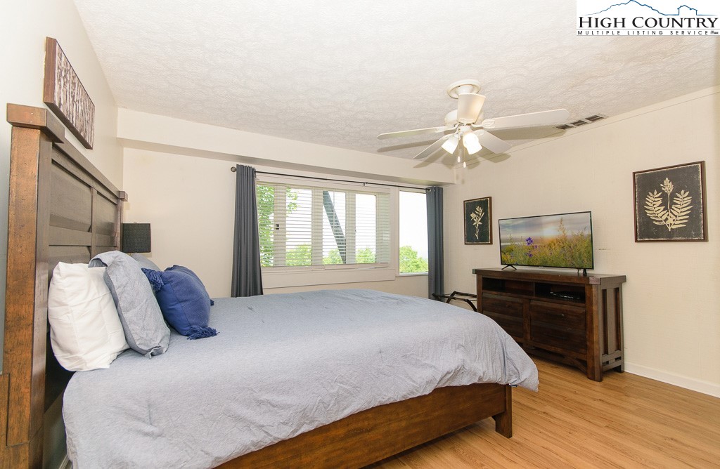 220 Northridge Road, Unit 25 Beech Mountain, NC 28604 - Photo 22 of 47 a bedroom with a bed and a flat screen tv