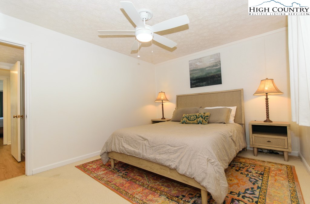 220 Northridge Road, Unit 25 Beech Mountain, NC 28604 - Photo 24 of 47 a bedroom with a bed and a ceiling fan