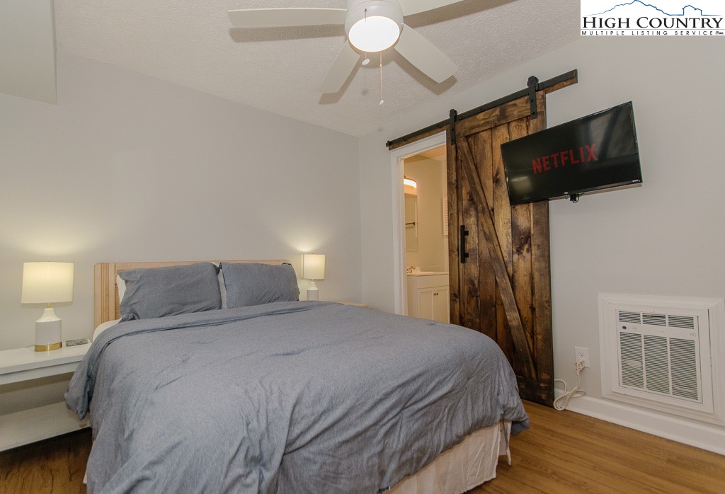 220 Northridge Road, Unit 25 Beech Mountain, NC 28604 - Photo 29 of 47 a bedroom with a bed and a flat screen tv