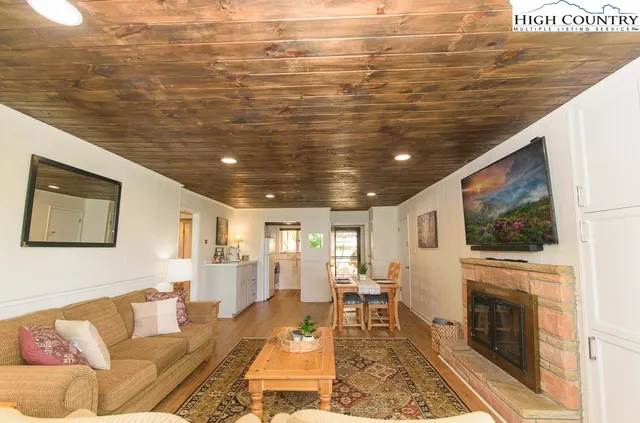 a living room with fireplace furniture and a flat screen tv