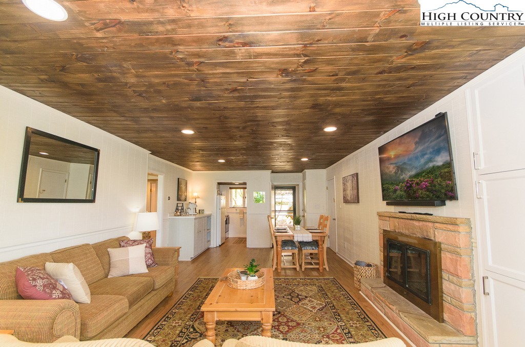 220 Northridge Road, Unit 25 Beech Mountain, NC 28604 - Photo 4 of 47 a living room with fireplace furniture and a flat screen tv