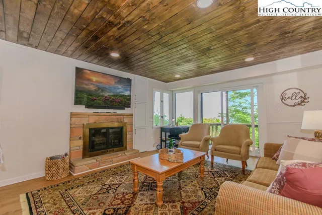 a living room with furniture a rug and a fireplace