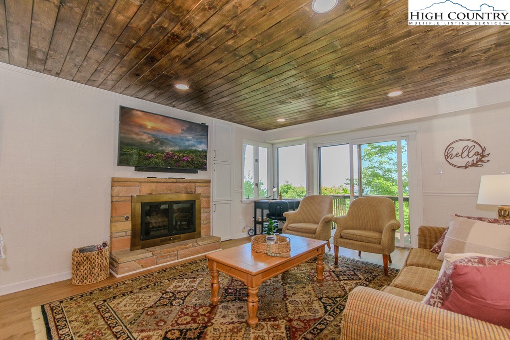 220 Northridge Road, Unit 25 Beech Mountain, NC 28604 - Photo 5 of 47 a living room with furniture a rug and a fireplace