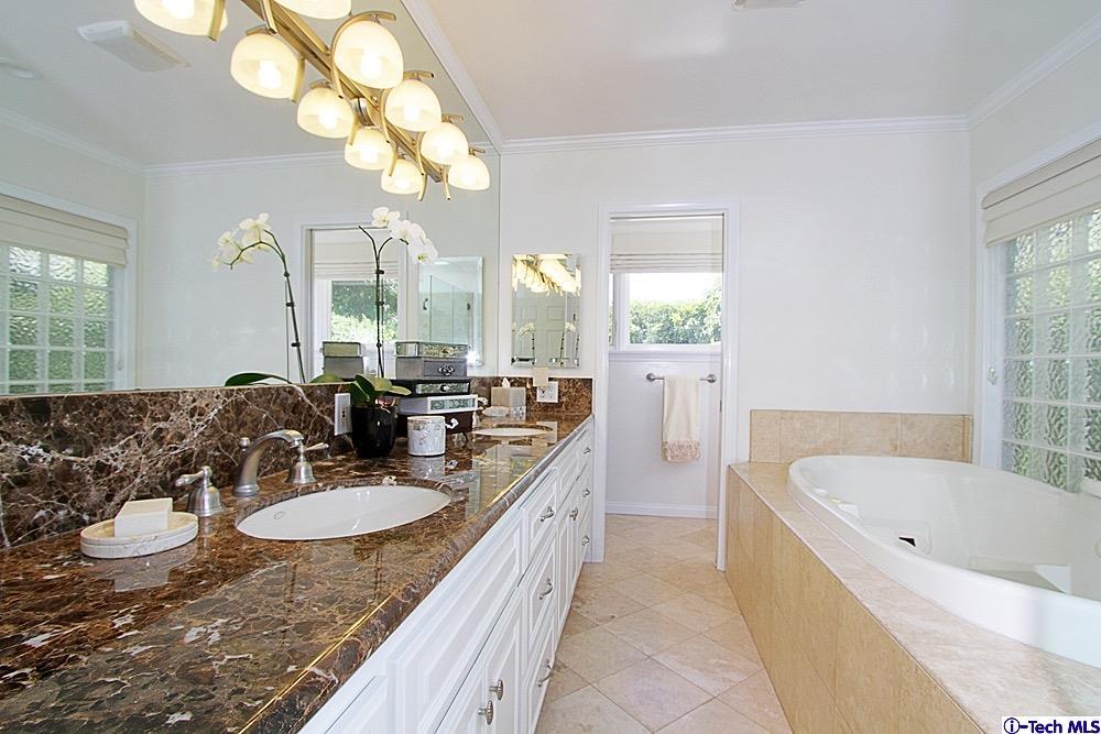 3690 Newhaven Road Pasadena, CA 91107 - Photo 15 of 21 a bathroom with a granite countertop sink a large mirror and a bathtub