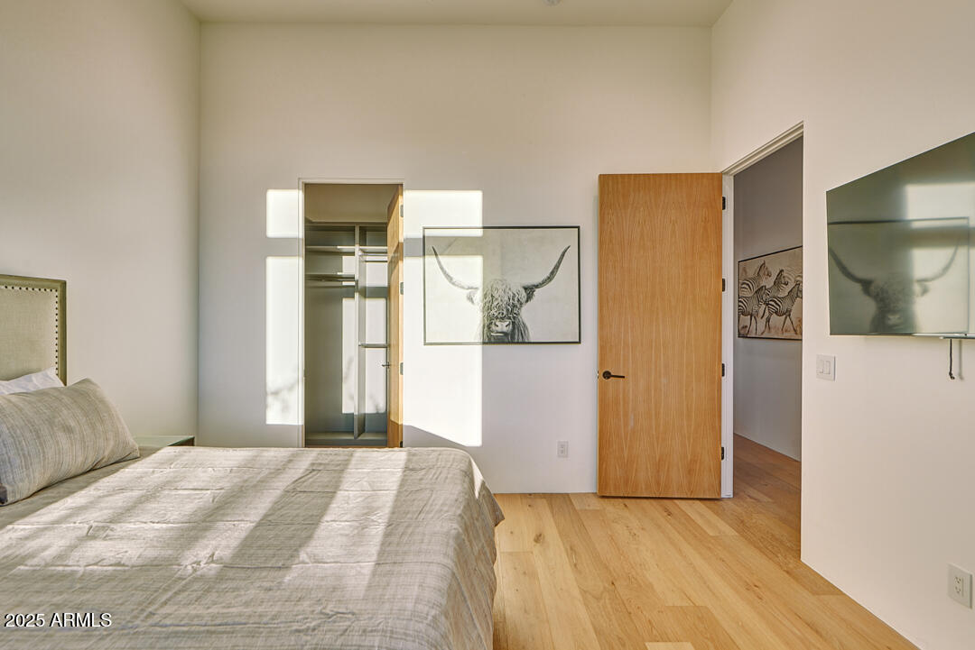 10249 East Joy Ranch Road Scottsdale, AZ 85262 - Photo 34 of 57 a bedroom with a bed and a mirror