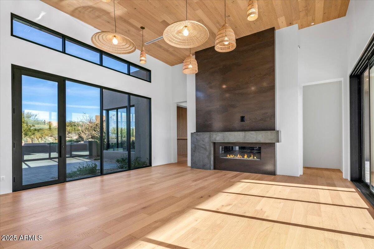 10249 East Joy Ranch Road Scottsdale, AZ 85262 - Photo 10 of 57 a view of an empty room with a fireplace and a floor to ceiling window
