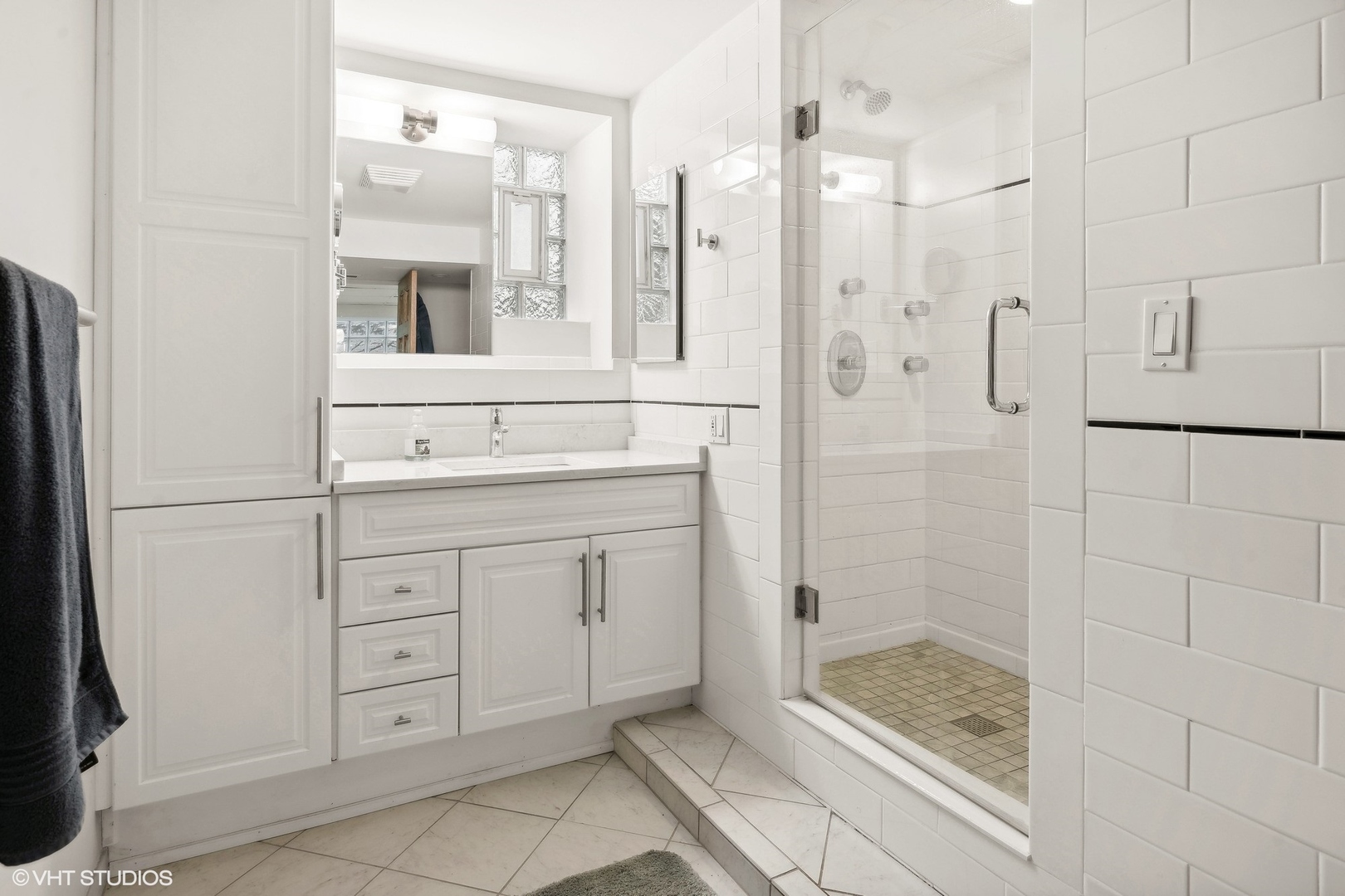 1920 West Addison Street Chicago, IL 60613 - Photo 14 of 34 a bathroom with a shower sink and mirror