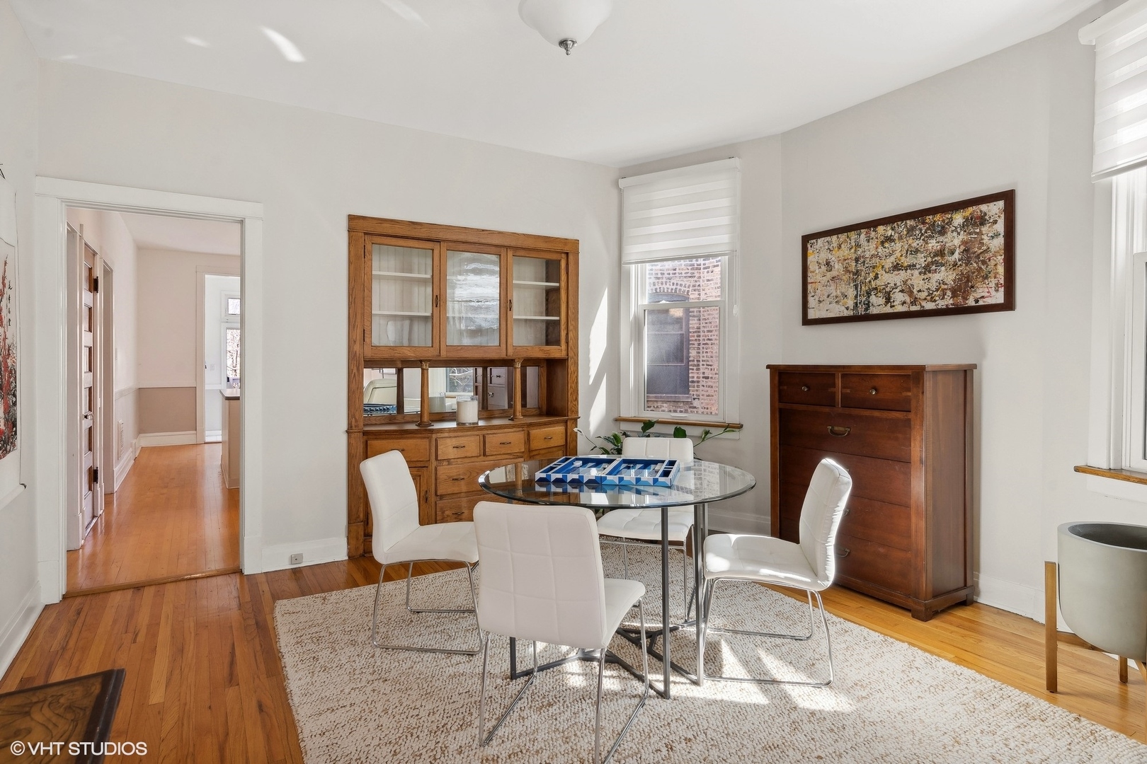 1920 West Addison Street Chicago, IL 60613 - Photo 20 of 34 a dining room with furniture a fireplace and wooden floor