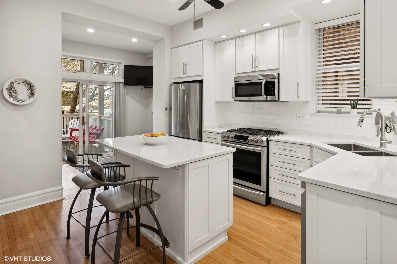 1920 West Addison Street Chicago, IL 60613 - Photo 10 of 34 a kitchen with stainless steel appliances kitchen island granite countertop a stove a sink a microwave and a refrigerator