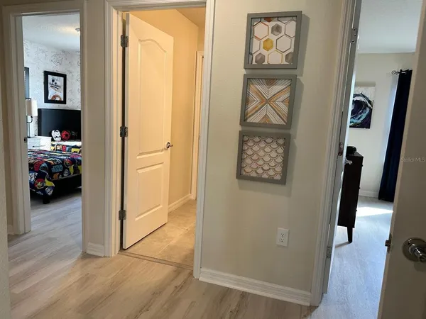 a view of a hallway view with wooden floor and closet