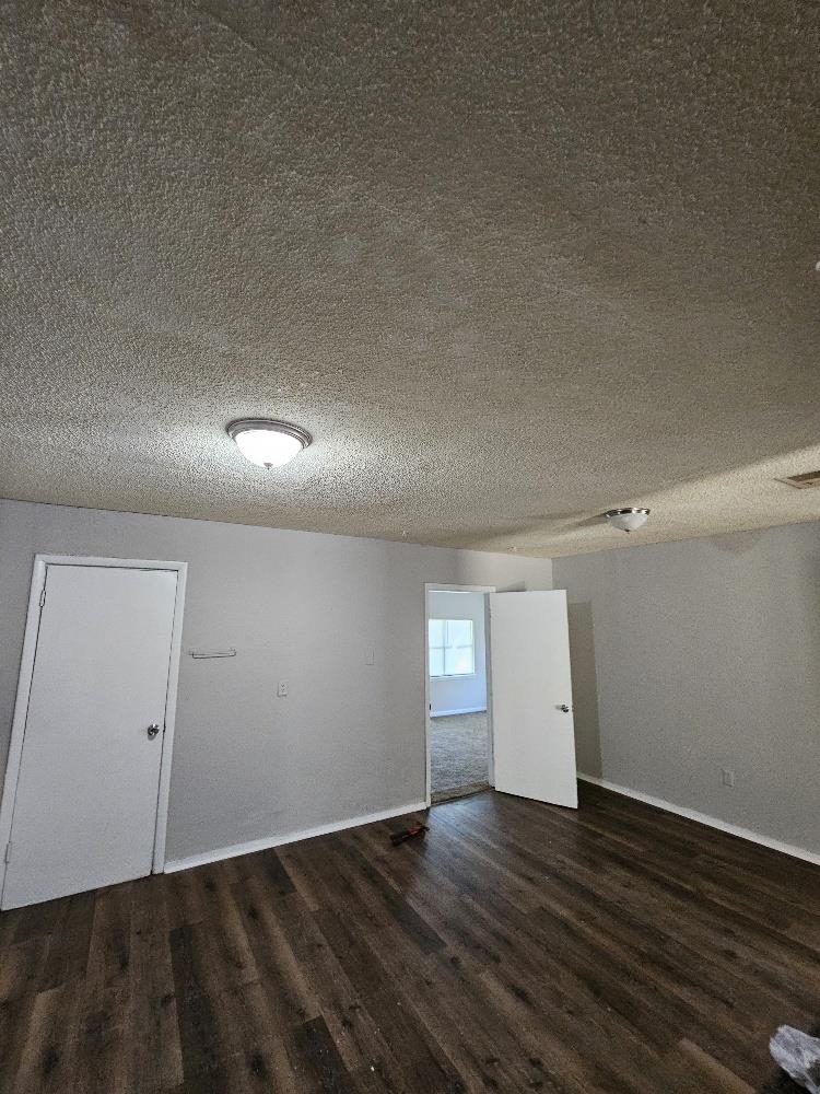 2249 Stephanie Avenue Memphis, TN 38127 - Photo 2 of 4 an empty room with wooden floor and windows