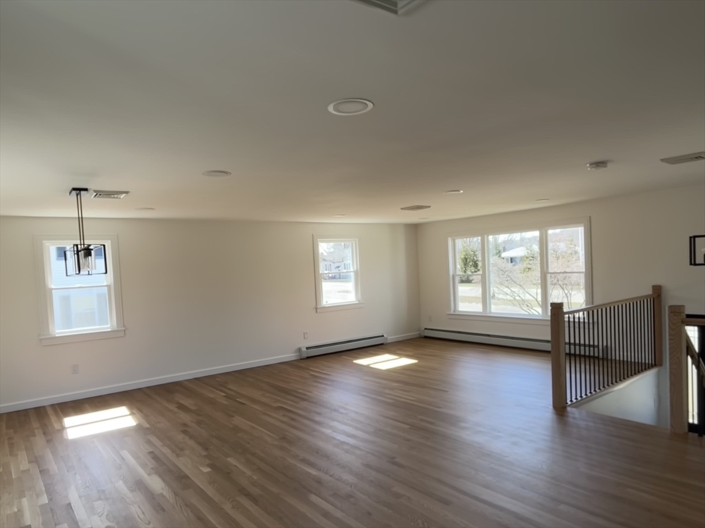 585 North Eastern Avenue Fall River, MA 02720 - Photo 13 of 26 an empty room with wooden floor and windows